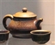 Dark-red enameled pottery teapot